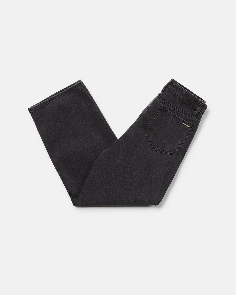 A pair of Volcom Boy's Big Boys' Billow Denim II Pants in black, folded neatly on a white background with the back pocket and waistband visible.