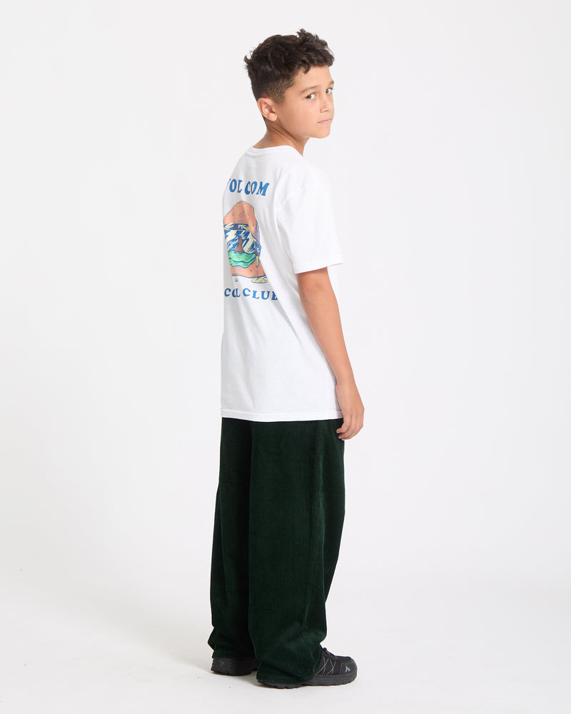 A boy with short dark hair stands sideways, looking over his shoulder. He wears the Kids' Burgstone Pocket Tee and dark green pants with black shoes, set against a plain white background.