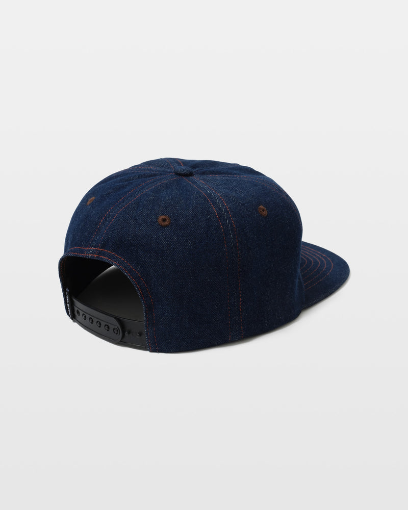 The Volcom Men's Hammered Work Hat is a dark blue denim snapback, shown from the back with red stitching and a black adjustable plastic strap.