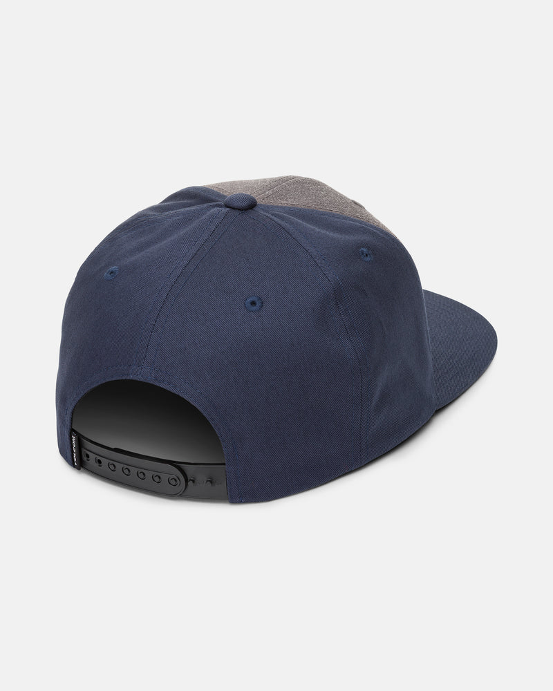 The Volcom Men’s Quarter Evo Twill hat in navy blue and gray is shown from the back, featuring a 6-panel design and an adjustable black plastic snapback strap.