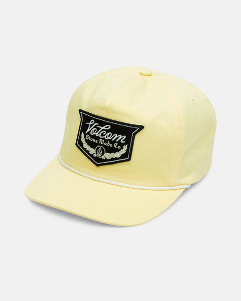 The Volcom Men's Stoney Mountain Hi Adjustable Hat is a pale yellow 5-panel cotton twill cap with a curved brim, white rope above the brim, and a black patch on the front that reads "Volcom Stone Made Co.