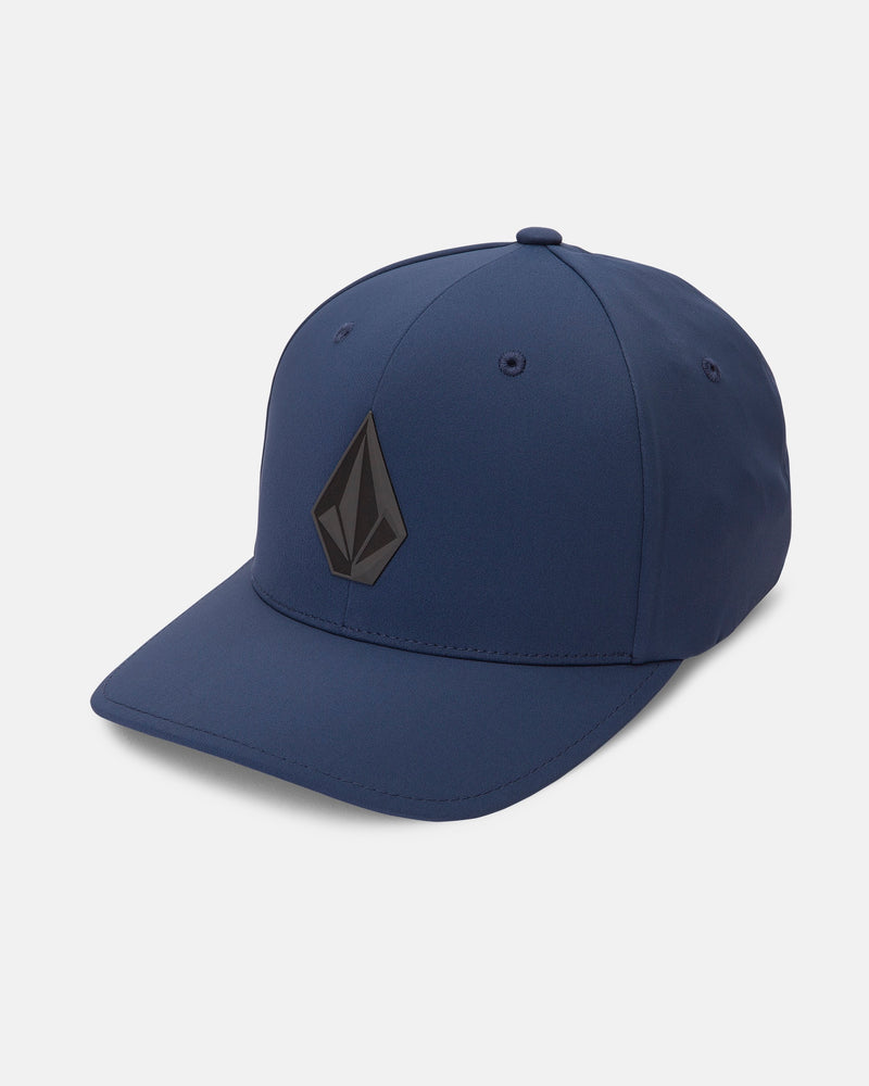 The Volcom Men's Stone Tech Flexfit Delta is a blue 6-panel crown baseball cap featuring a black geometric logo on the front, displayed at a slight angle against a plain white background.