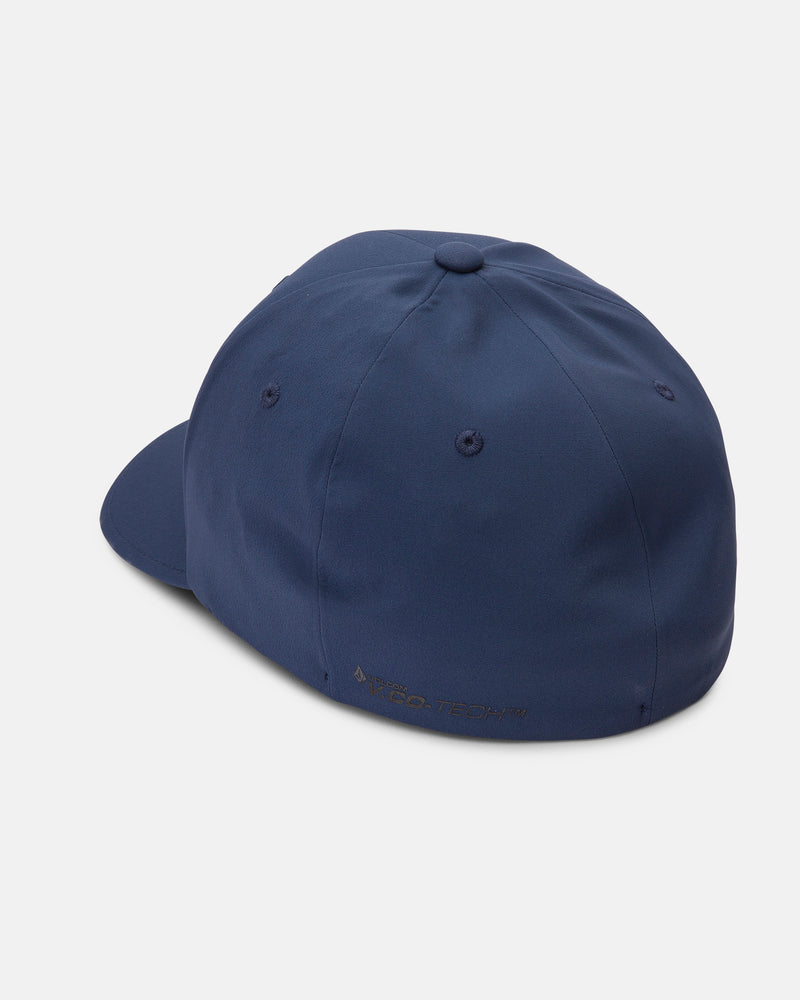 A rear side view of the Volcom Men's Stone Tech Flexfit Delta cap in navy, featuring a smooth, unadorned back, ventilation eyelets, moisture-wicking fabric, and subtle RECO-TECH™ text near the edge of its 6-panel crown.