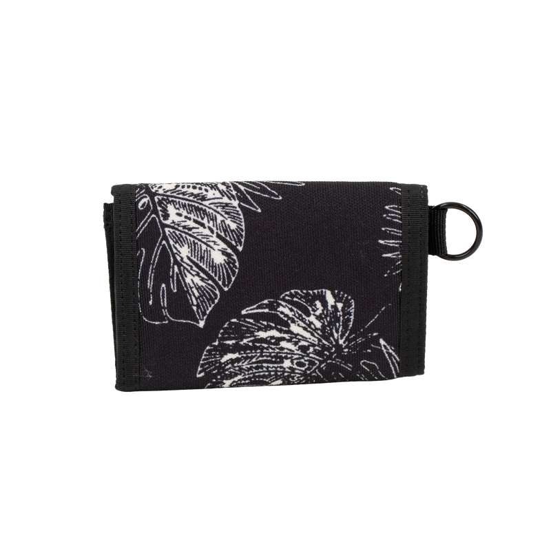The Men's Box Stone Wallet by Volcom is a black fabric wallet adorned with white leaf patterns, black trim, and a metal keyring on the right side. It features convenient card slots for your essentials and is displayed against a plain white background.