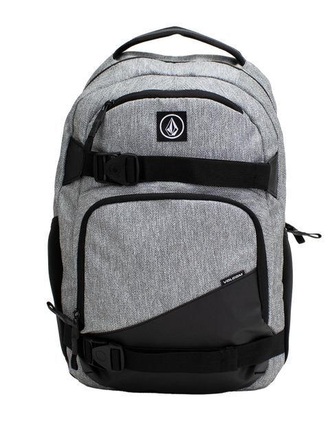 A Volcom Men's Grindstone Skate Backpack in gray and black, featuring two front zippered pockets, black adjustable straps with buckles, a padded laptop sleeve, and a top handle, displayed against a plain white background.
