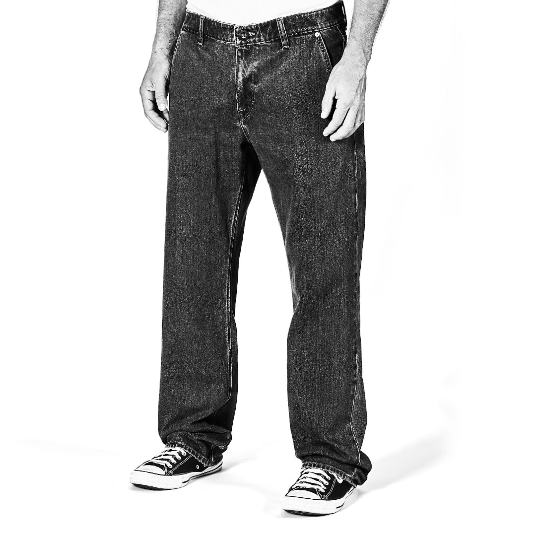 Black and white image of person wearing jeans and sneakers on a white background