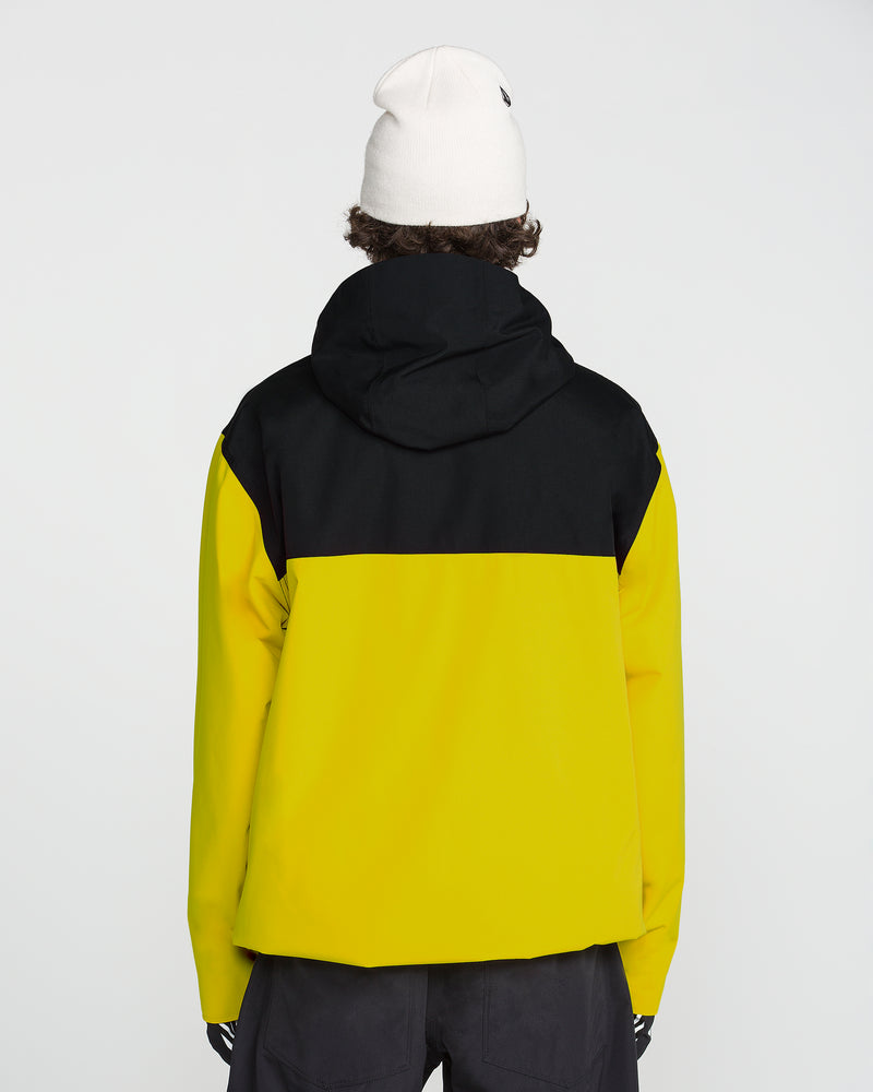 A person faces away from the camera, wearing the Volcom Men’s Buckthreeeighty Insulated Jacket in yellow and black—featuring a hood and crafted from recycled fabric—paired with a white beanie and black pants, set against a plain light background.