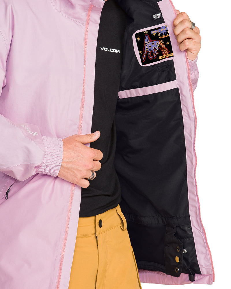 A person wears a light purple Men’s Longo Gore-Tex Jacket open over a black shirt and yellow pants, revealing an interior lining with a colorful graphic patch of a horse.