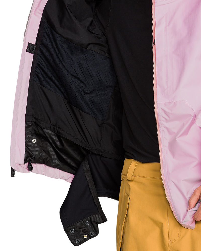 Close-up of the light pink interior of a Men’s Longo Gore-Tex Jacket, showing a black mesh pocket and a powder skirt with snap buttons.