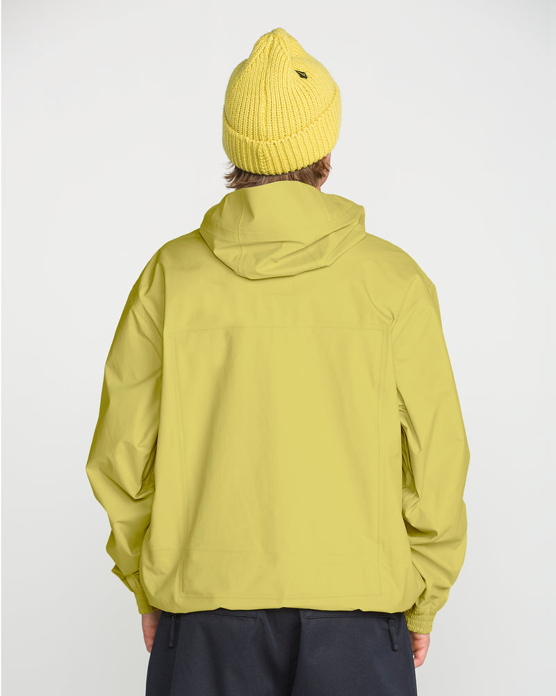 A person facing away, wearing a yellow knit beanie, dark pants, and the Volcom Men’s Arthur 3L 20K Jacket—with storm-grade V-Science 3-Layer protection—stands against a plain light background.