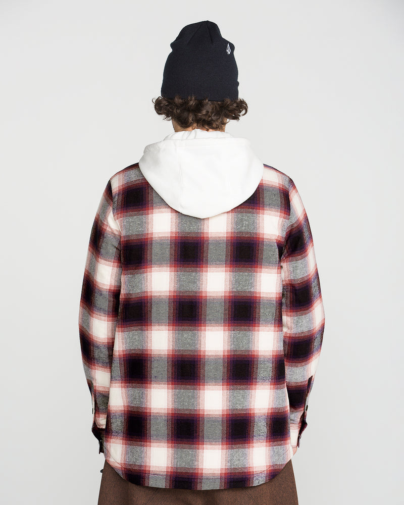A person with curly hair, wearing a black beanie, a Volcom Men’s Enson Insulated Riding Flannel in red, white, and black, and a white fleece hood is facing away from the camera against a plain white background.