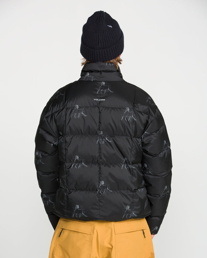 A person faces away, wearing a black beanie and the Volcom Men’s Arthur Down Puff Jacket featuring a PFAS-free DWR finish and subtle designs, paired with mustard yellow pants. Plain white background.