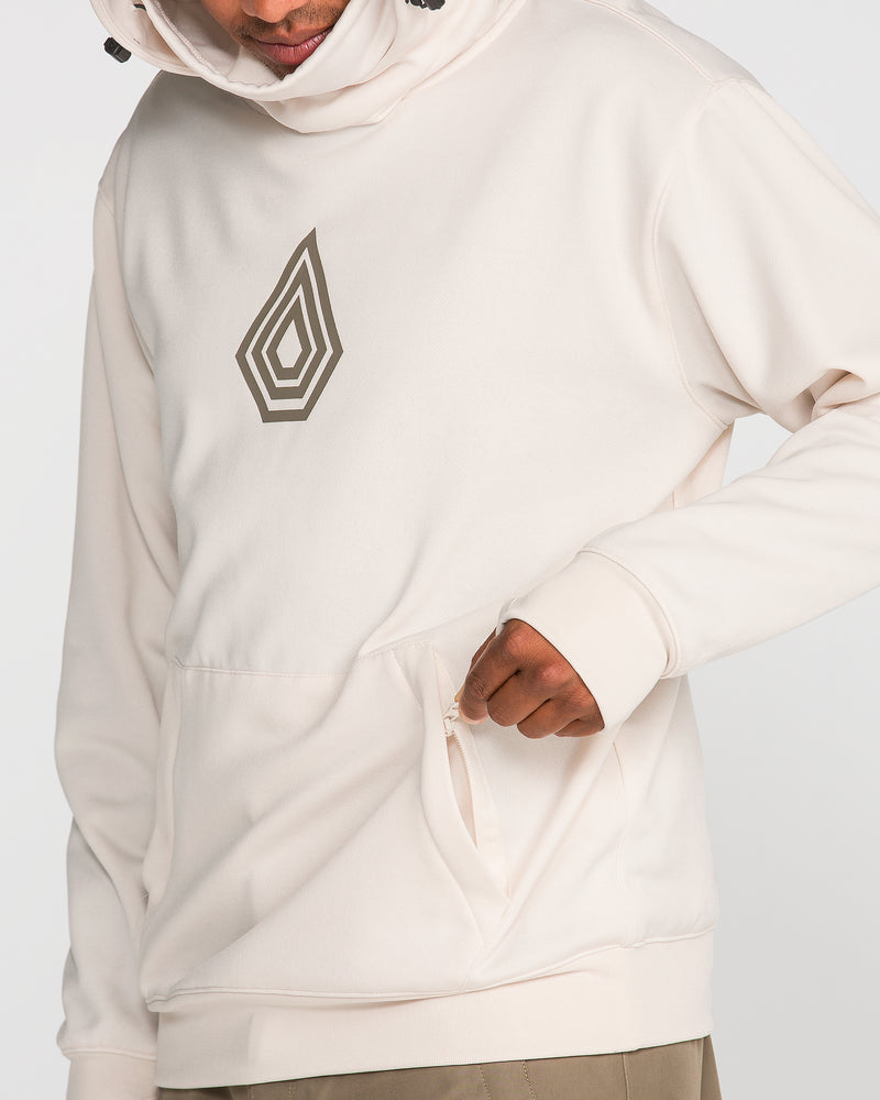 Wearing the Volcom Men’s Hydro Riding Hoodie in light beige, featuring a geometric design on the chest, a person unzips a pocket near the waist. Crafted from hydrophobic fleece, this hoodie delivers comfort and protection with its innovative material. Only the lower face and torso are shown.