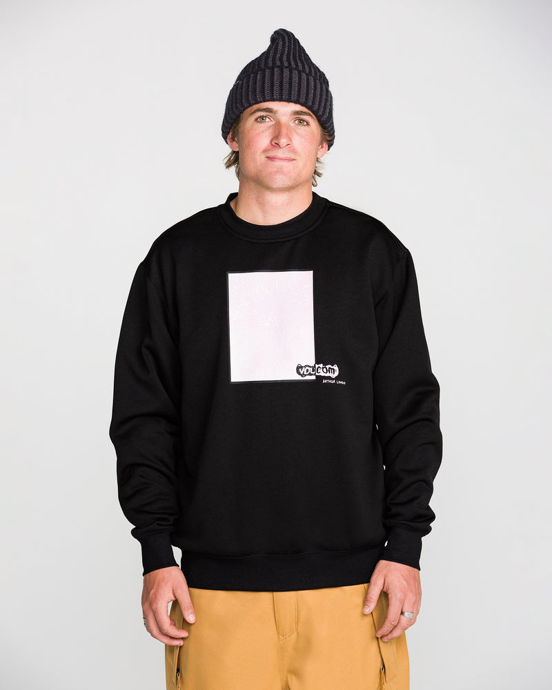A person wearing the Volcom Men’s Hydro Crew black sweatshirt, along with a black beanie and tan pants, stands in front of a plain light gray background and looks at the camera with a neutral expression.