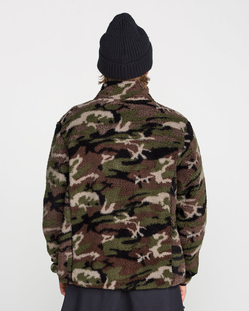 A person is shown from the back, standing against a plain white background, wearing the Volcom Men’s Nelson Sherpa Full Zip—a fuzzy camouflage fleece jacket—and a black beanie.