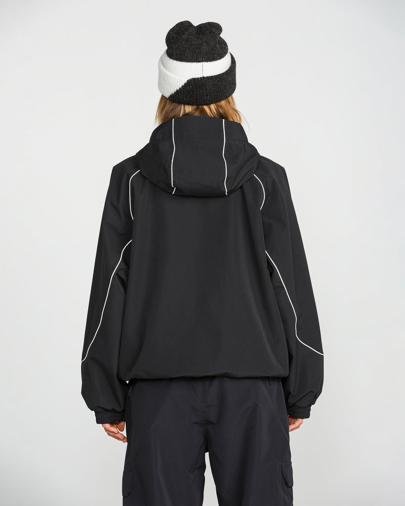 A person stands facing away from the camera against a plain light background, wearing the Volcom Unisex Liftline 20K Jacket in black with white piping, paired with black pants and a black and white beanie, showcasing stylish snowboarding apparel.