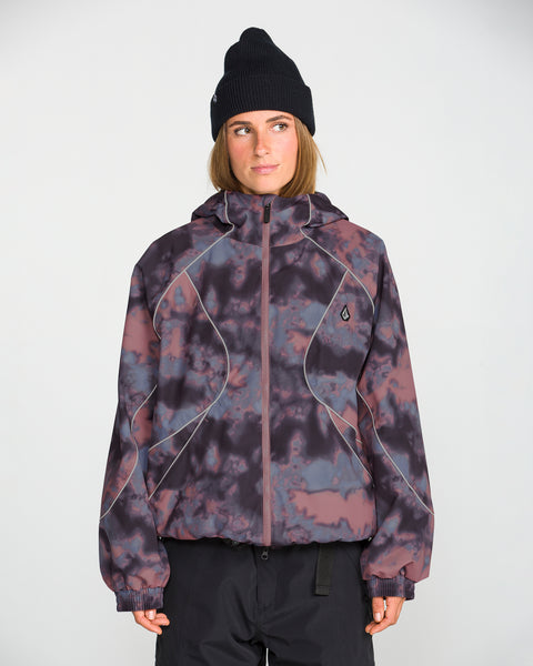 A person stands facing forward against a plain white background, wearing the Volcom Unisex Liftline 20K Jacket in a purple and black pattern with a baggy fit, paired with a black beanie and their hands at their sides.