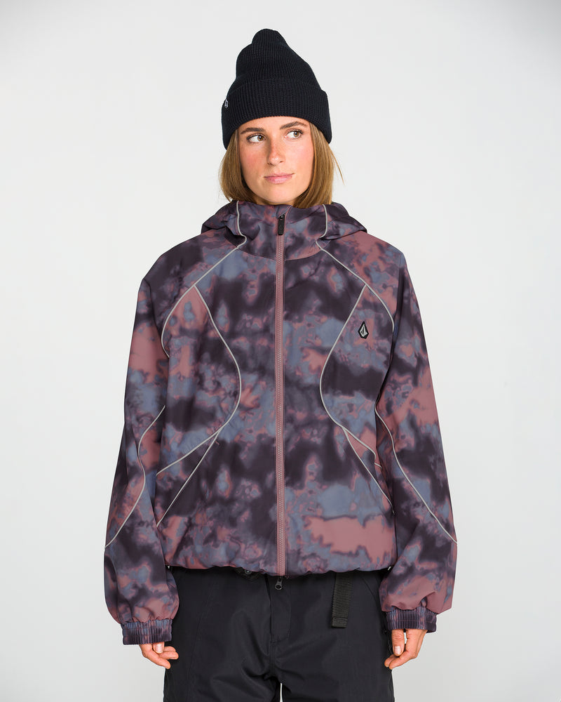 A person stands facing forward against a plain white background, wearing the Volcom Unisex Liftline 20K Jacket in a purple and black pattern with a baggy fit, paired with a black beanie and their hands at their sides.