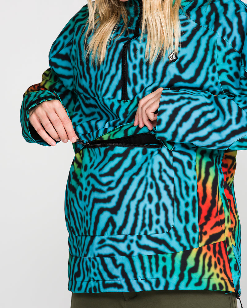 A person, with only their torso and hands visible, is unzipping the front pocket of the Volcom Women’s Harlan Pullover—a turquoise, blue, and orange zebra-striped jacket featuring V-Science 2-Layer construction.