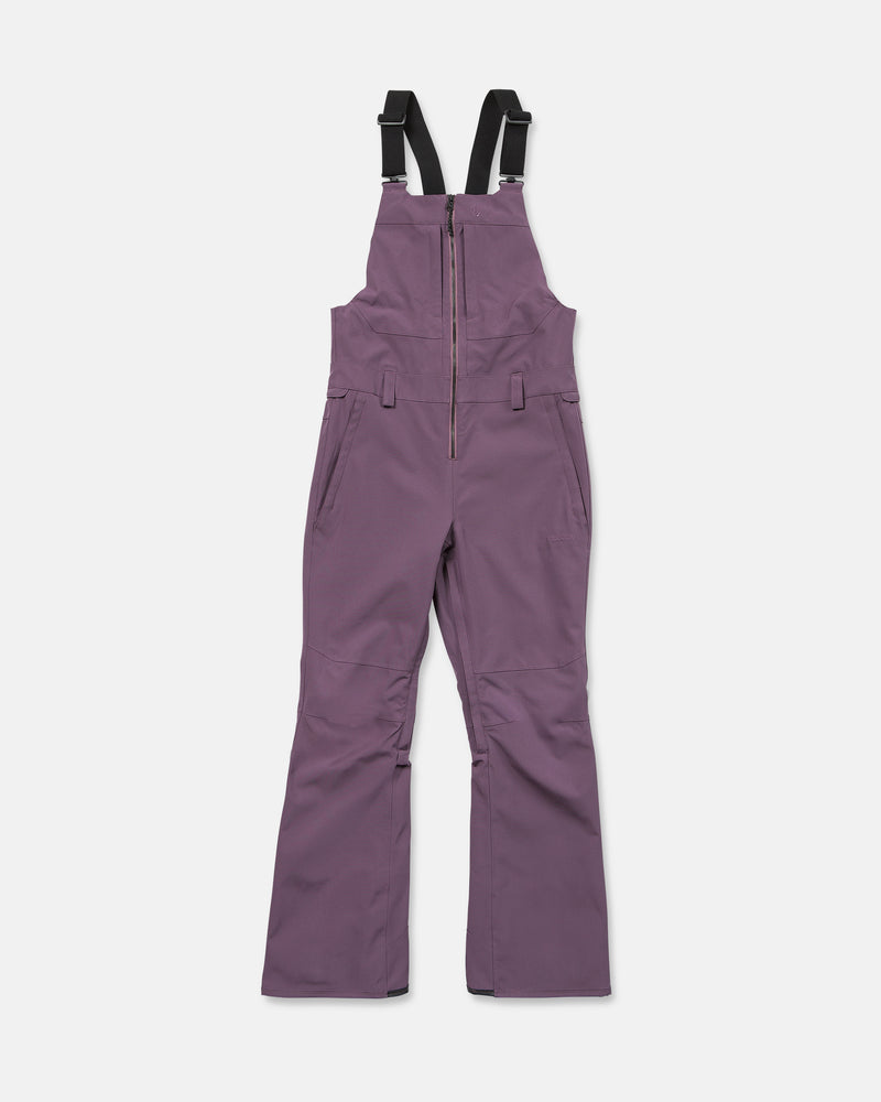 Volcom Women’s Swift Bib snow pants in purple, crafted from recycled fabric with a waterproof finish, front zipper, adjustable black shoulder straps, and side pockets—displayed flat on a white background.