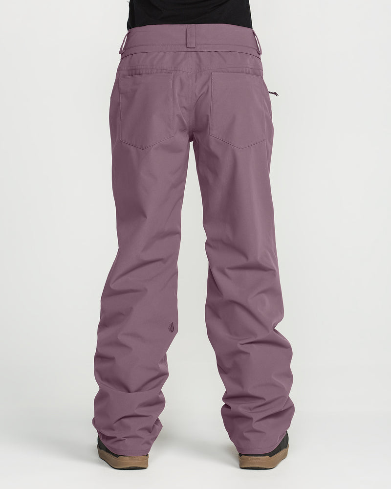 A person is shown from the back against a plain white background wearing the Volcom Women’s Stoned Pants in purple, paired with brown shoes.