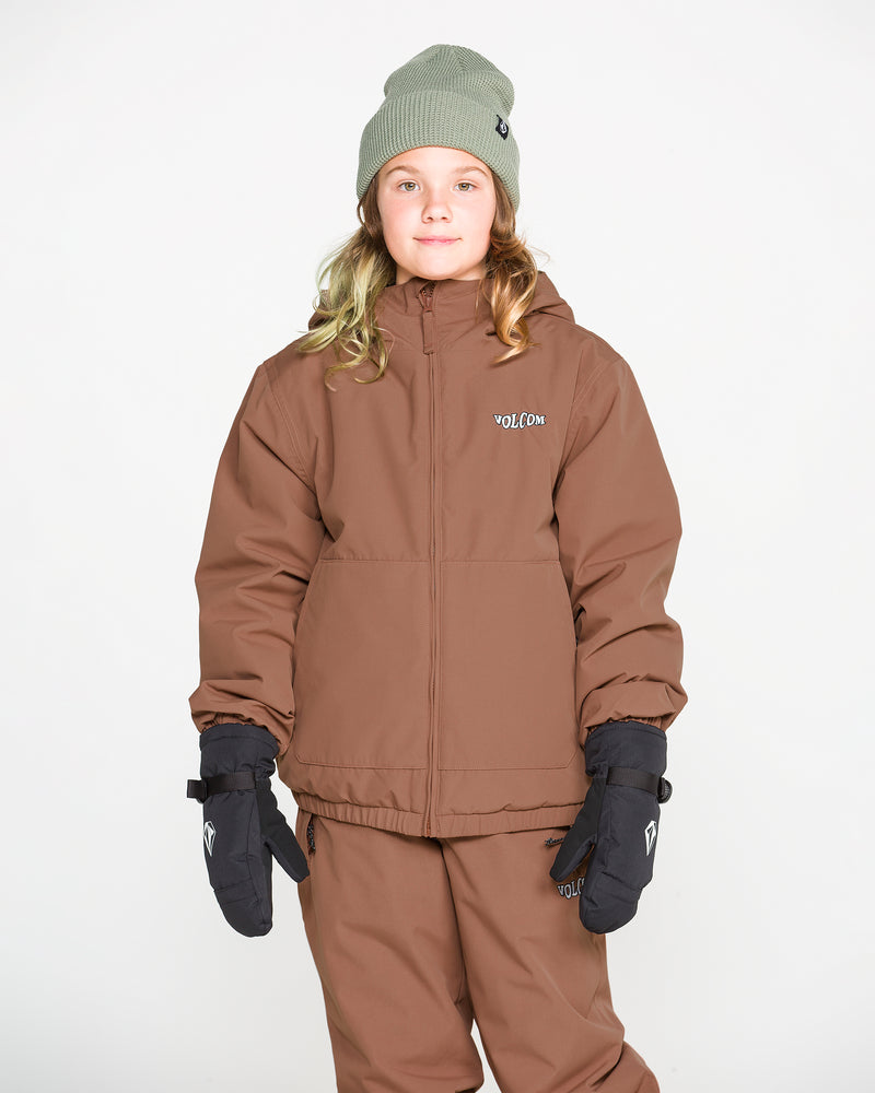 A young person stands against a plain white background, facing the camera with a slight smile, wearing a brown Volcom Kids’ Youth Chaos Insulated Jacket featuring recycled insulation and Weather Defense technology, paired with matching pants, black gloves, and a light green beanie.