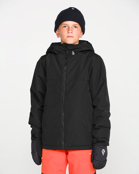 A young person wearing a black beanie, black gloves, bright orange pants, and the Volcom Kids’ Youth Stone.91 Insulated Jacket with Grow-Tech features stands facing forward against a plain white background.