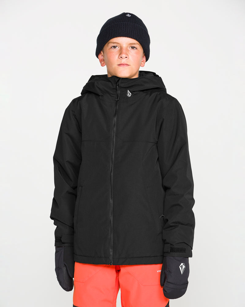 A young person wearing a black beanie, black gloves, bright orange pants, and the Volcom Kids’ Youth Stone.91 Insulated Jacket with Grow-Tech features stands facing forward against a plain white background.