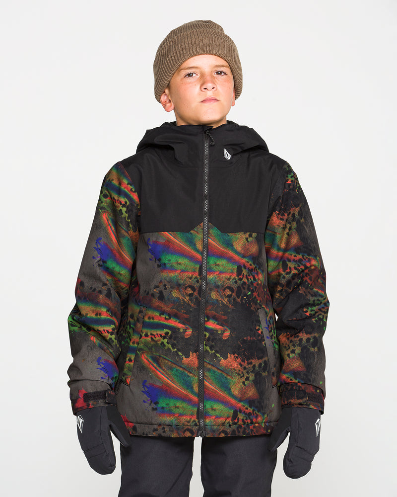 A boy stands against a plain white background, looking directly at the camera, dressed in a brown beanie, black gloves, and the Volcom Kids’ Youth Stone.91 Insulated Jacket—a colorful patterned youth snow jacket featuring recycled insulation and a black top section.