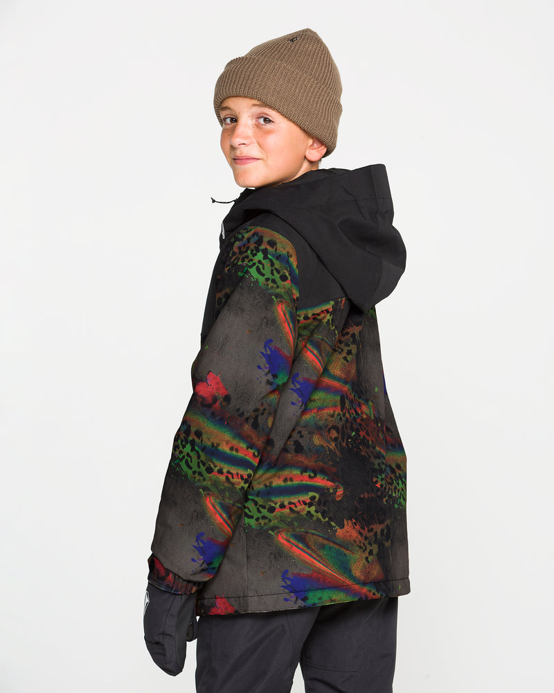 A young boy wearing the Volcom Kids’ Youth Stone.91 Insulated Jacket and a brown beanie smiles over his shoulder at the camera, against a plain white background.