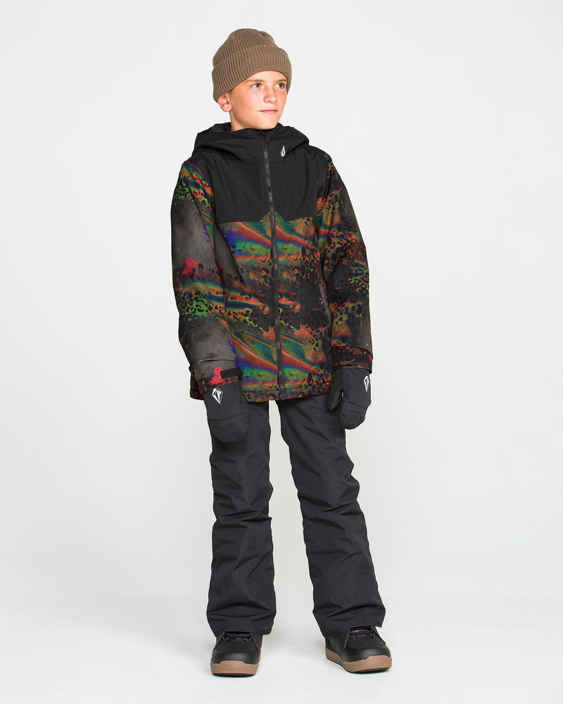 A boy wearing a brown beanie, Volcom Kids’ Youth Stone.91 Insulated Jacket with recycled insulation, black snow pants, black gloves, and boots stands against a plain white background, looking off to the side. The multicolored jacket features Grow-Tech for lasting comfort as he grows.