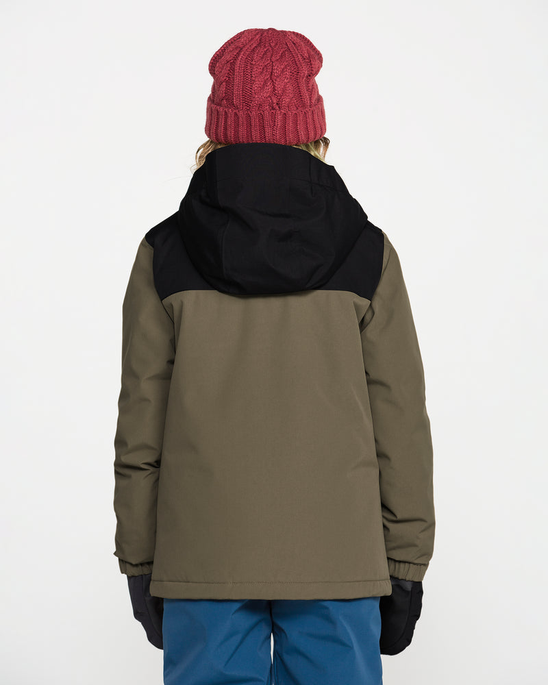 A person wearing a red knit hat, blue pants, black gloves, and the Volcom Kids’ Youth Stone.91 Insulated Jacket in green and black with recycled insulation stands facing away from the camera against a plain white background.