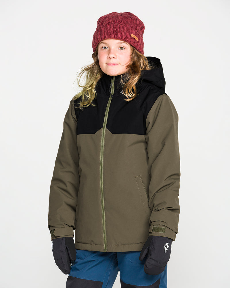 A child wearing a red knit beanie, blue pants, black gloves, and the Volcom Kids’ Youth Stone.91 Insulated Jacket in green and black with recycled insulation stands facing forward against a plain white background.