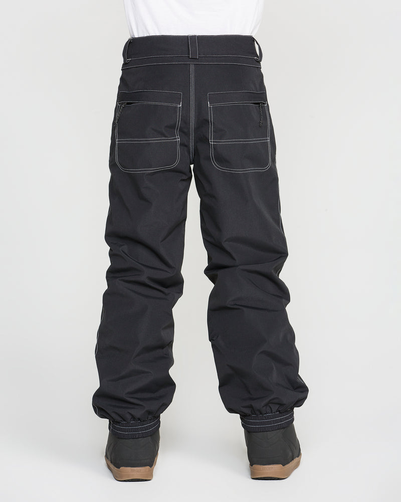 A person is pictured from behind against a plain white background, wearing the Volcom Kids’ Youth Chaos Insulated Pants in black. The pants feature white stitching, two zippered back pockets, and are paired with black boots. Designed with recycled insulation, these pants offer 10K/10K protection.
