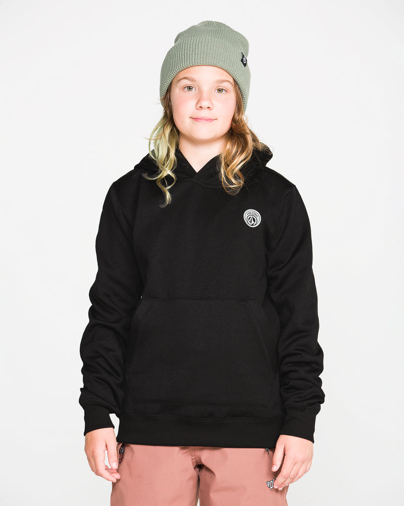 A young person wearing a gray beanie, Volcom Kids’ Youth Hydro Fleece Hoodie in black, and pink pants stands against a plain white background, facing forward with a neutral expression.