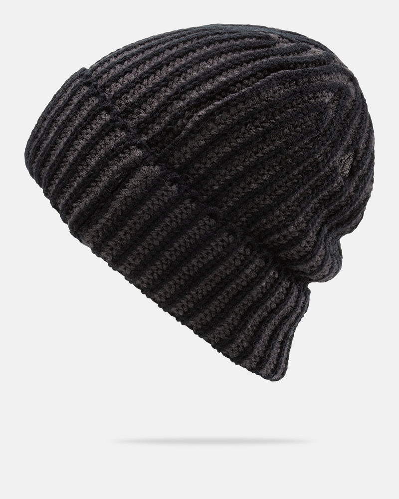 A side view of the Volcom Men’s Knit Stoned Beanie in black, featuring a ribbed texture and slouch fit, crafted from 100% acrylic, displayed against a plain white background.