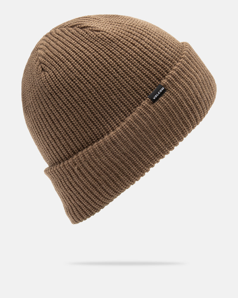 The Volcom Men’s Sweep Lined Beanie is a brown knitted hat featuring a folded brim and a small black rectangular Volcom tag. Designed with a cozy fleece lining, the beanie is shown floating against a plain white background.