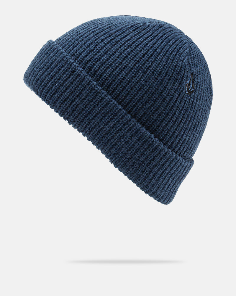 The Volcom Men’s Sweep Beanie is shown against a white background. This cozy blue knit beanie features a folded brim, a small black embroidered Volcom logo near the edge, and offers a standard fit for comfortable everyday wear.