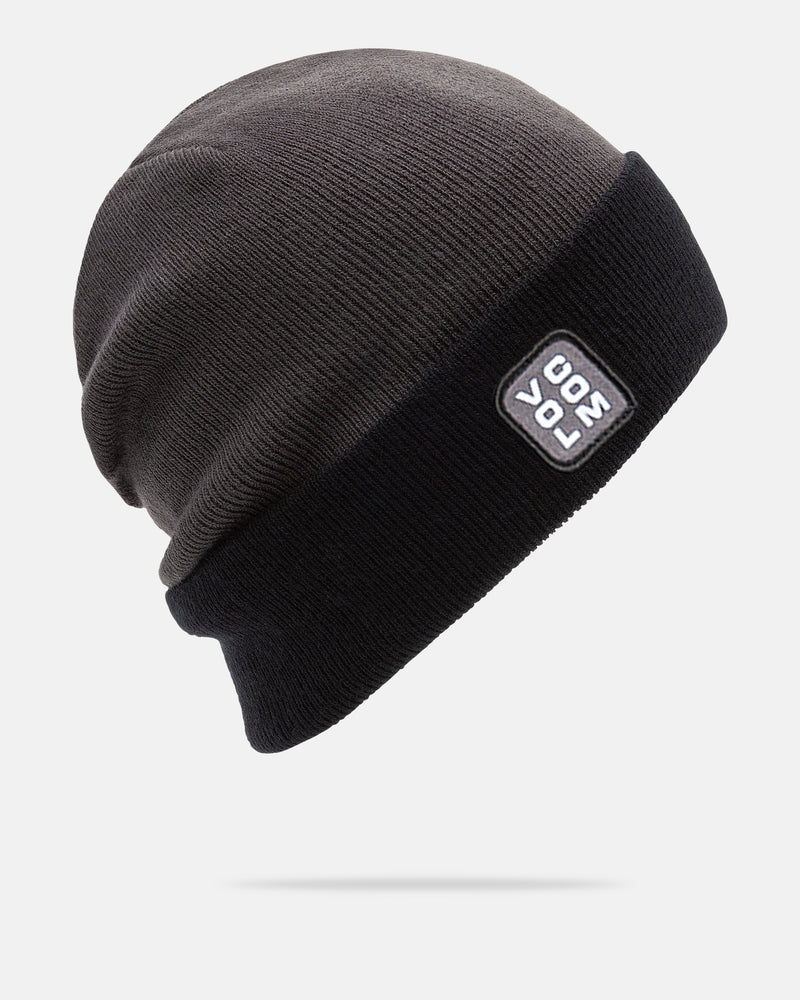 A dark knit acrylic Volcom Men’s Team Beanie featuring a black folded brim and a rectangular patch with “POL 300” in white text, displayed against a plain white background. This beanie combines warmth and style for any occasion.