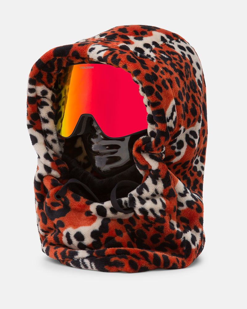 A black mannequin head wears the Volcom Women’s Dang Hood—a cozy fleece hood featuring a bold red, black, and white leopard print pattern—paired with red reflective ski goggles. The Dang Hood provides full head and neck coverage, acting as an effective neck warmer and making it perfect for cold weather adventures.