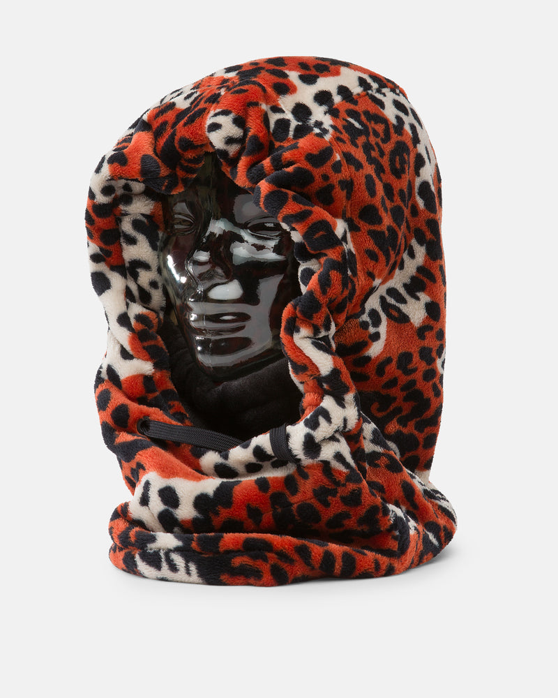A shiny black mannequin head displays the Volcom Women’s Dang Hood, a thick, plush fleece hood featuring a red, black, and white leopard print pattern that covers the head and neck—perfect as a cozy neck warmer for cold weather.