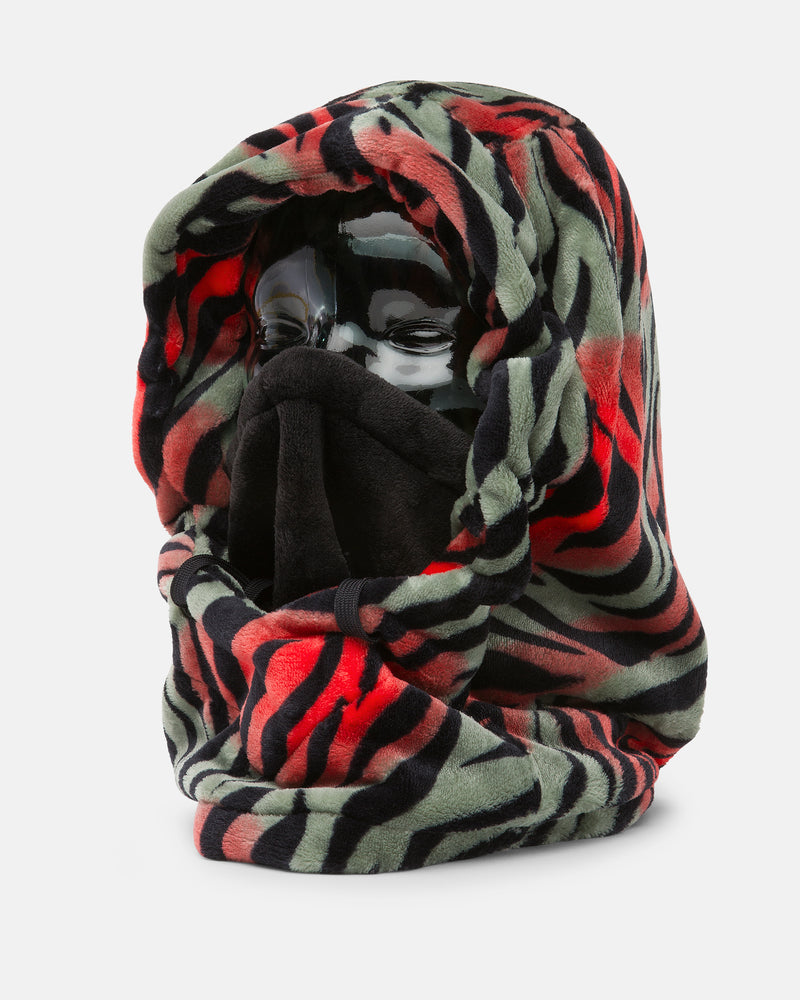 A mannequin head is draped with the Volcom Women’s Dang Hood, a thick, fuzzy fleece hood scarf featuring black, red, and green tiger stripes that covers most of the face except for the eyes—making it a perfect neck warmer for cold weather.