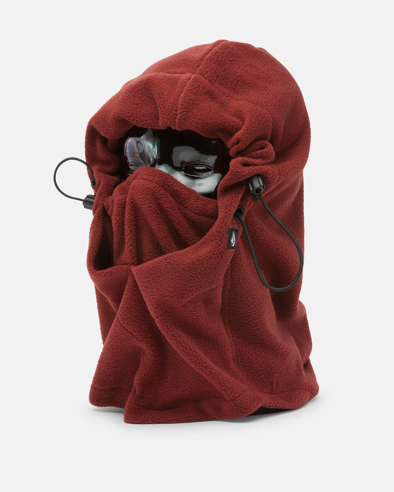A mannequin head is shown wearing the Women’s V.Scout Hood by Volcom—a deep red fleece pullover hood featuring drawstrings and an adjustable toggle, covering the face except for the eyes, which are protected by black goggles.