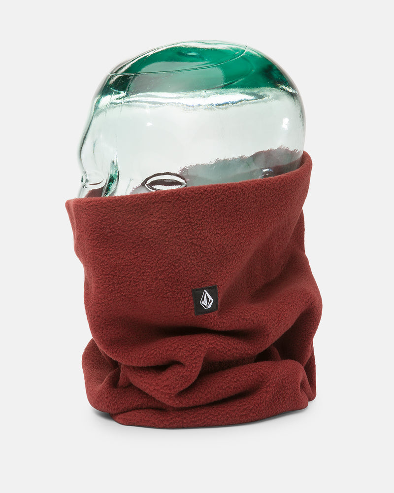 A clear glass head mannequin displays the Volcom Women’s V.Scout Neckband, a maroon polyester fleece accessory featuring a small black and white logo tag on the front, providing both warmth and comfort against a plain white background.