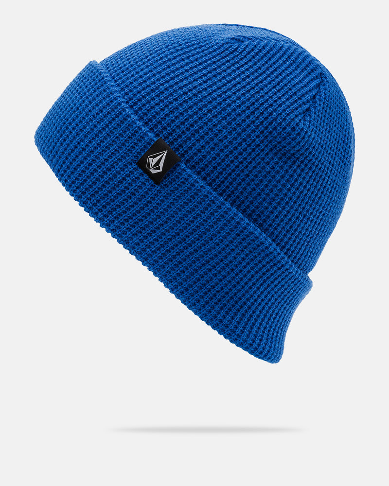 Bright blue Volcom Women’s Power Beanie with a folded brim and a small black rectangular tag featuring the signature white geometric Volcom logo, displayed against a plain white background. This stylish beanie blends comfort and modern flair.