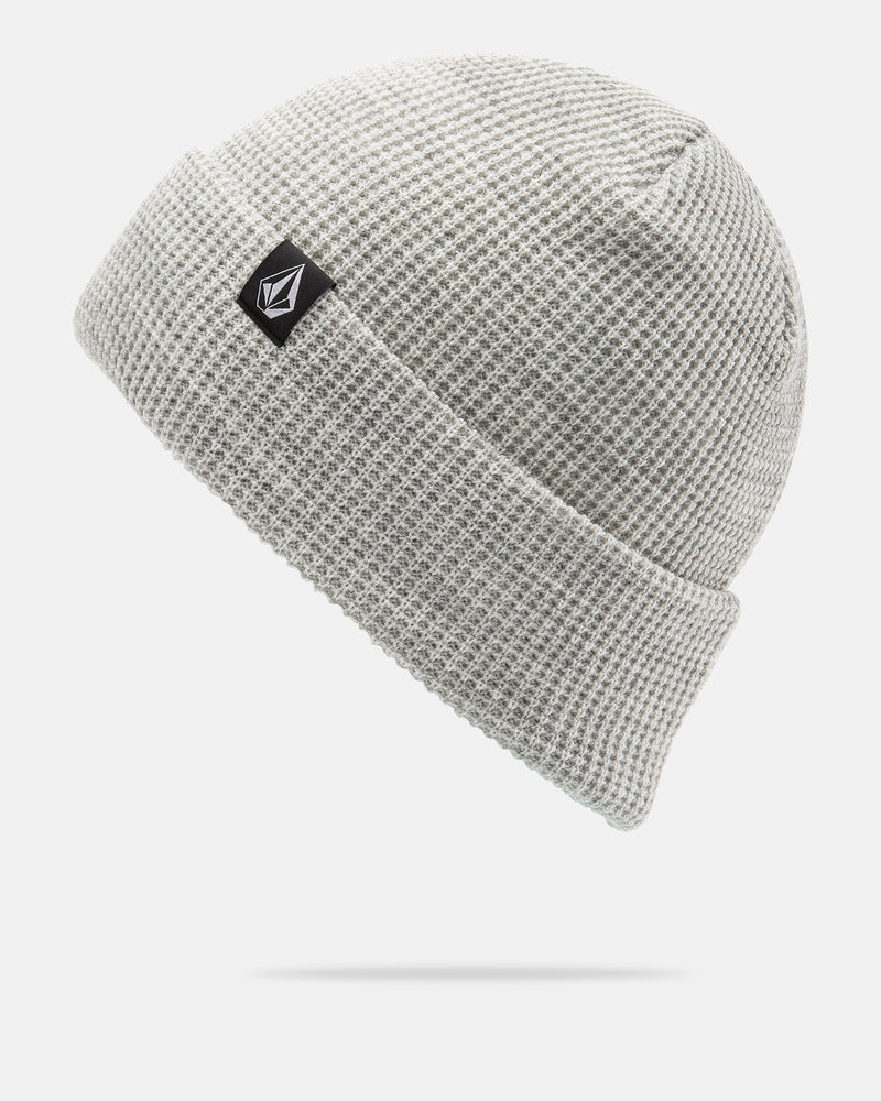 A light gray Volcom Women’s Power Beanie featuring a waffle-knit texture, folded brim, and a small black and white rectangular logo patch on the front, designed for on-mountain sessions and shown against a white background.