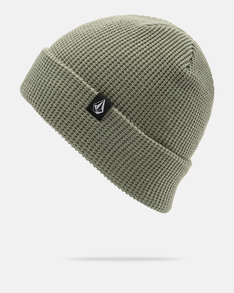 The Volcom Women’s Power Beanie in olive green features a folded brim and a small black patch with a white geometric logo on the front. It is displayed against a plain white background.