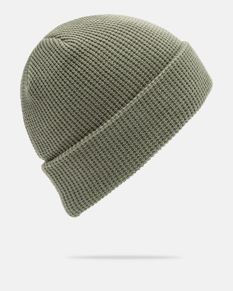 A light gray-green Women’s Power Beanie by Volcom, crafted in acrylic with a folded brim, is displayed against a white background. The beanie appears to float above the surface, casting a soft shadow beneath it.