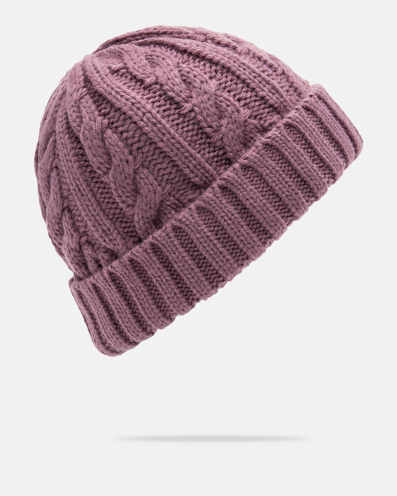The Volcom Women’s Stone Knit Beanie is shown on a white background, featuring a classic cable knit pattern with a ribbed cuff in mauve.