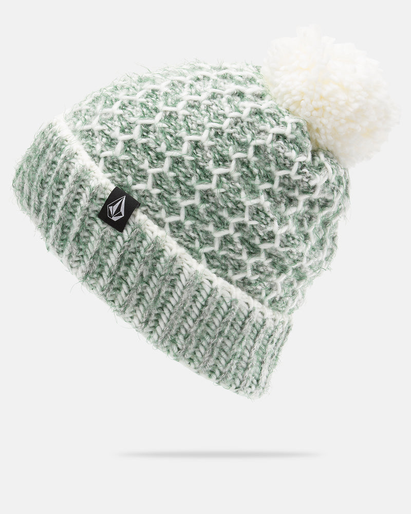 Introducing the Volcom Women’s Frosty Top Beanie—a green and white knitted winter hat designed for women, showcasing a textured diamond pattern. This cozy beanie features a soft white folded brim, is topped with a large faux fur pom, and includes a small black Volcom logo tag on the brim for a stylish finish.